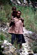 Villager from Dani tribe carrying small child. Papua, Indonesia.
