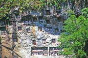 Traditional graves at Lemo village. Tau tau figures can be seen at galleries in front of graves. Tana Toraja area. Sulawesi, Indonesia.