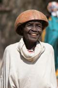 Woman at Tourou village at Mandara Mountains. Local fashion is red wooden calabashes on women' heads. They look rather like army helmets and which indicate things like their marital status. Cameroon.