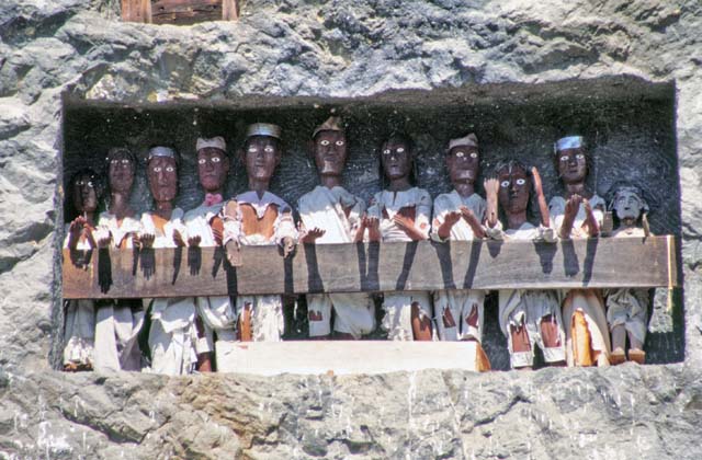 Tau tau figures in front of graves at Lemo. Tana Toraja area. Sulawesi,  Indonesia.