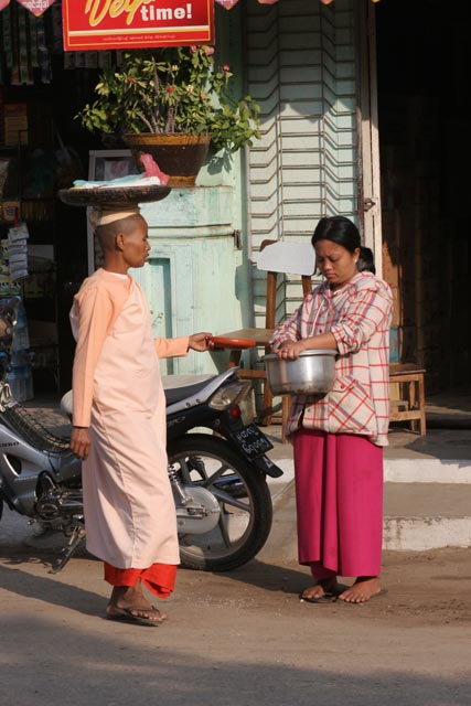 Monks are going through the village each morning. They are gathering the rice for the whole day. Nyaung U. Myanmar (Burma).