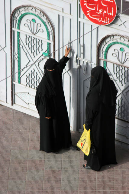 Traditional women clothes have black color. Al-Mukalla town. Yemen.