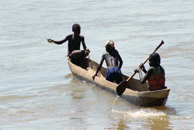 Local villagers in pirogue at Tsiribihina river. Madagascar.